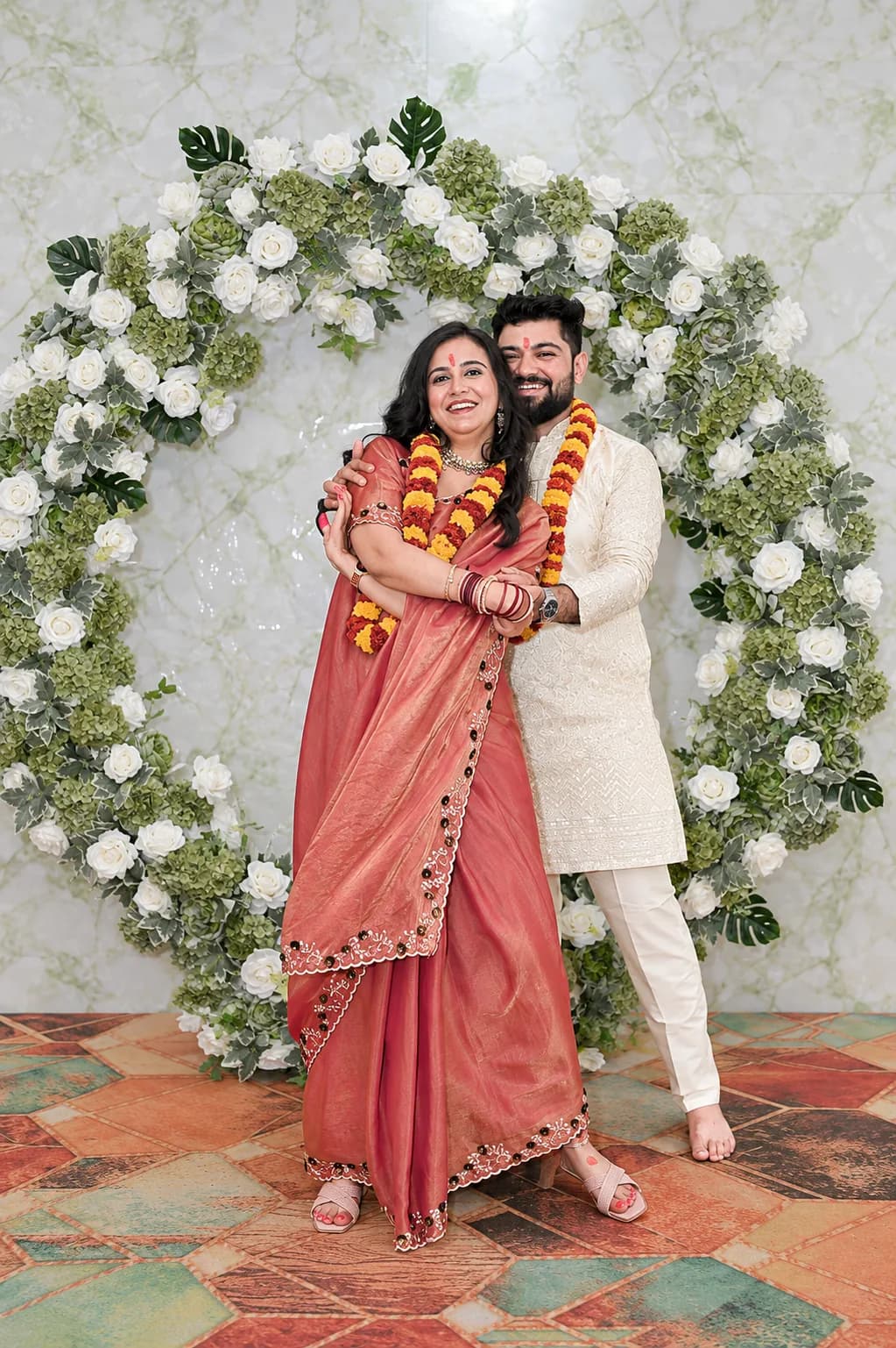 Yogesh and Akanksha with marigold garlands